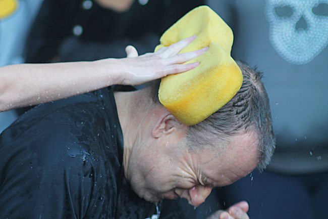 Teacher having a sponge rubbed on their head